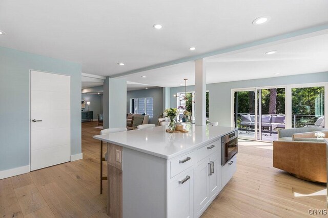 3 Elson Ln, Skaneateles, NY 13152 - kitchen featuring open floor plan, white cabinets, light wood-style flooring, and recessed lighting