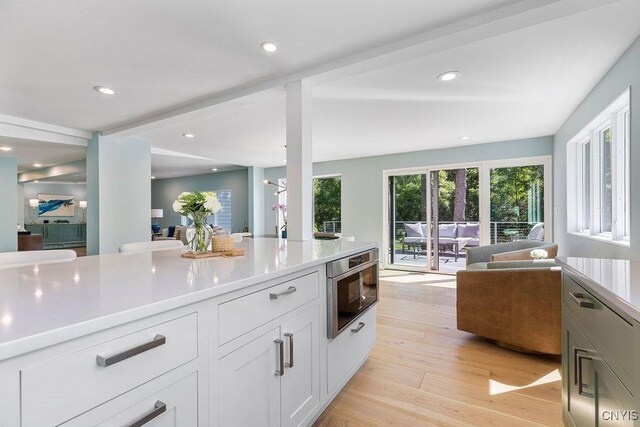 3 Elson Ln, Skaneateles, NY 13152 - kitchen featuring open floor plan, light countertops, light wood-type flooring, white cabinetry, and recessed lighting