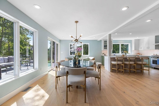 3 Elson Ln, Skaneateles, NY 13152 - dining area featuring light wood-type flooring, a chandelier, recessed lighting, and baseboards