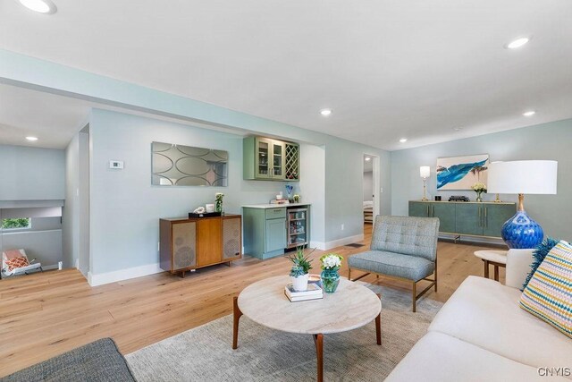 3 Elson Ln, Skaneateles, NY 13152 - living area featuring beverage cooler, a bar, light wood-type flooring, baseboards, and recessed lighting