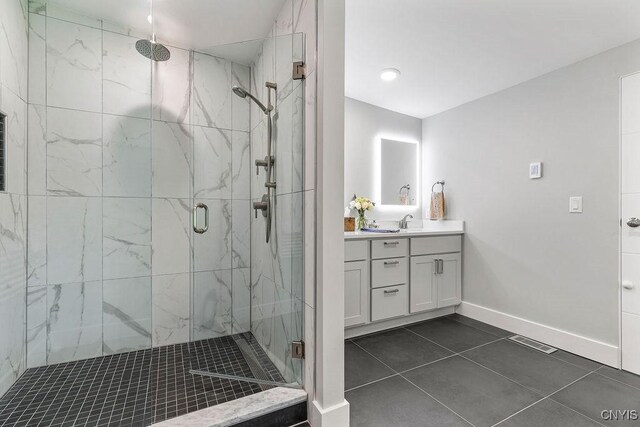 3 Elson Ln, Skaneateles, NY 13152 - full bath with a marble finish shower, vanity, tile patterned floors, and baseboards