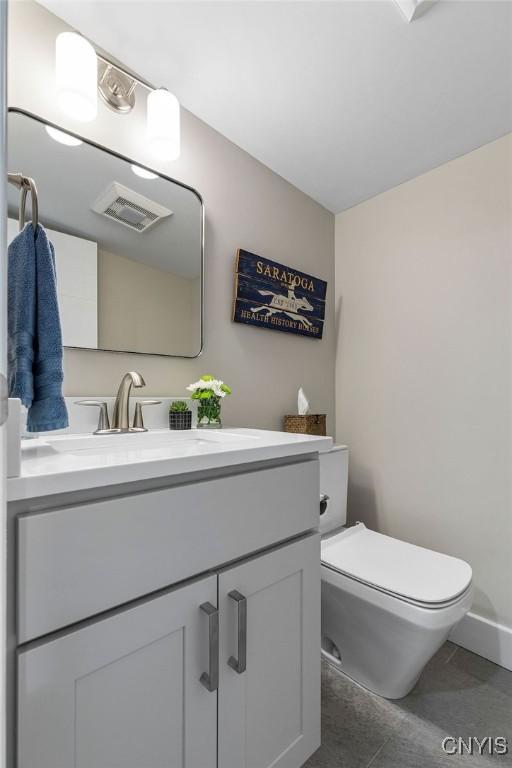 3 Elson Ln, Skaneateles, NY 13152 - bathroom featuring vanity, toilet, and baseboards