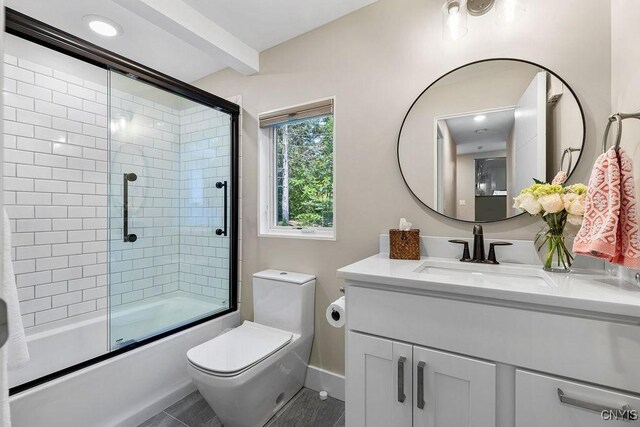 3 Elson Ln, Skaneateles, NY 13152 - full bathroom with vanity, bath / shower combo with glass door, toilet, baseboards, and beam ceiling