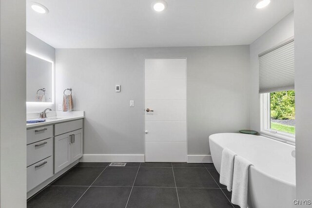 3 Elson Ln, Skaneateles, NY 13152 - bathroom featuring vanity, baseboards, a freestanding bath, tile patterned flooring, and recessed lighting