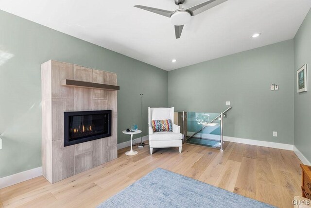 3 Elson Ln, Skaneateles, NY 13152 - living area with baseboards, wood finished floors, a tile fireplace, and recessed lighting