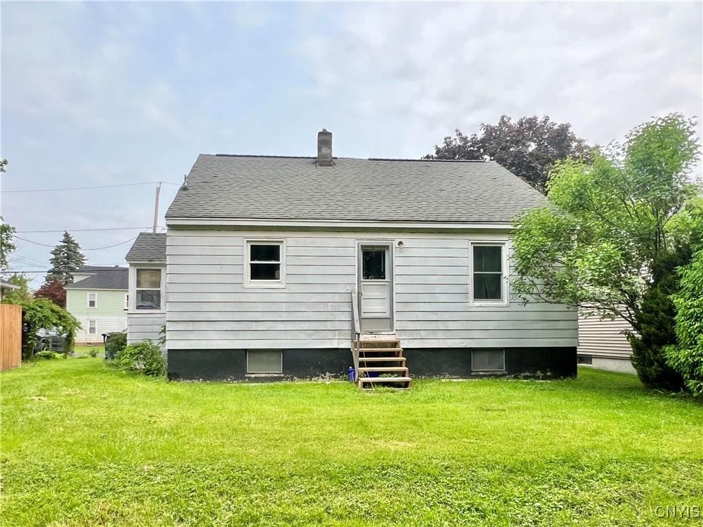 114 Myron Rd, Camillus, NY 13219 - rear view of property with entry steps, a lawn, a shingled roof, and a chimney