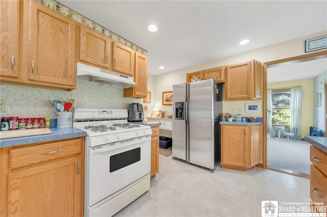 7080 Goodrich Rd, Clarence, NY 14032 - kitchen with under cabinet range hood, stainless steel fridge with ice dispenser, white gas range oven, and recessed lighting