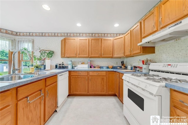 7080 Goodrich Rd, Clarence, NY 14032 - kitchen with white appliances, under cabinet range hood, a sink, wallpapered walls, and light countertops