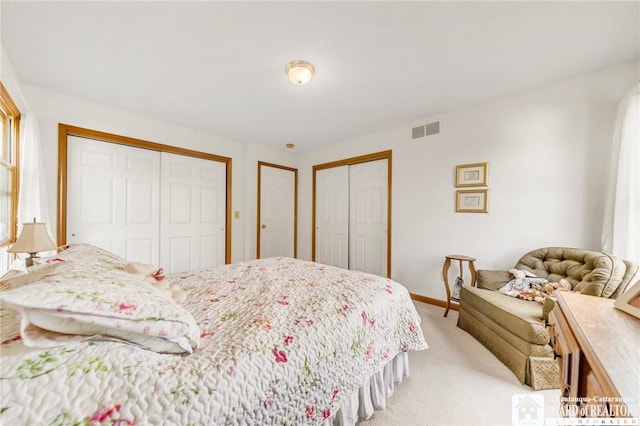 7080 Goodrich Rd, Clarence, NY 14032 - bedroom with multiple closets, light carpet, and baseboards