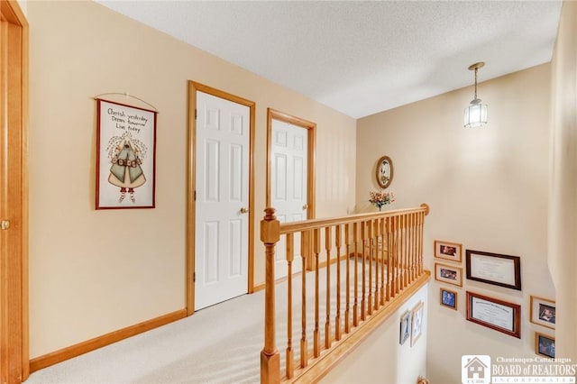 7080 Goodrich Rd, Clarence, NY 14032 - hallway featuring an upstairs landing, carpet flooring, a textured ceiling, and baseboards