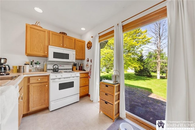 7080 Goodrich Rd, Clarence, NY 14032 - kitchen with white appliances, light countertops, and recessed lighting