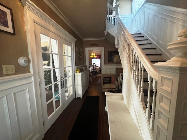 14 Park St, Bradford-City, PA 16701 - stairway featuring french doors, a decorative wall, crown molding, a wainscoted wall, and wood finished floors