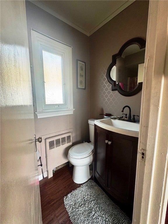 14 Park St, Bradford-City, PA 16701 - half bathroom featuring radiator, vanity, wood finished floors, toilet, and crown molding
