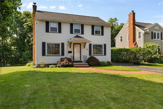 55 Heberton Rd, Irondequoit, NY 14622 - colonial-style house featuring a front yard and a chimney