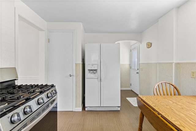55 Heberton Rd, Irondequoit, NY 14622 - kitchen with white fridge with ice dispenser, stainless steel gas range, and arched walkways