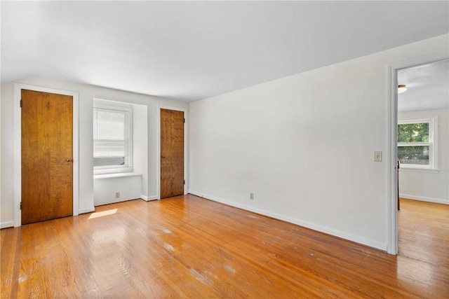 55 Heberton Rd, Irondequoit, NY 14622 - unfurnished bedroom with light wood-type flooring, baseboards, and multiple closets