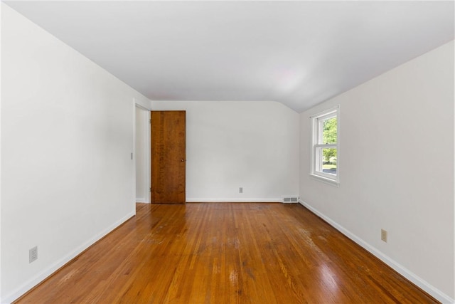 55 Heberton Rd, Irondequoit, NY 14622 - empty room featuring vaulted ceiling, hardwood / wood-style floors, and baseboards