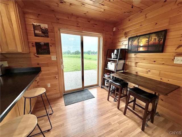 25003 State Route 37, Pamelia, NY 13601 - dining space with wood ceiling, wooden walls, and light wood-style flooring