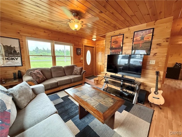 25003 State Route 37, Pamelia, NY 13601 - living room featuring wooden walls, wood finished floors, wood ceiling, and a ceiling fan