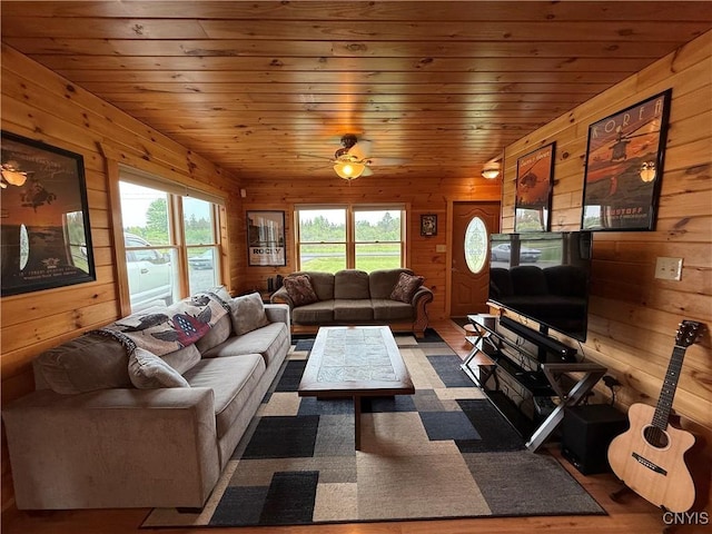 25003 State Route 37, Pamelia, NY 13601 - living room with wooden walls, healthy amount of natural light, wooden ceiling, and wood finished floors