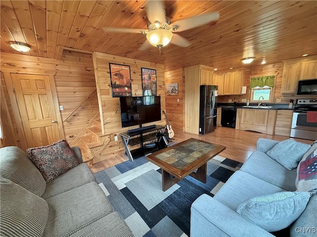25003 State Route 37, Pamelia, NY 13601 - living area featuring light wood-style floors, ceiling fan, wooden walls, and wood ceiling