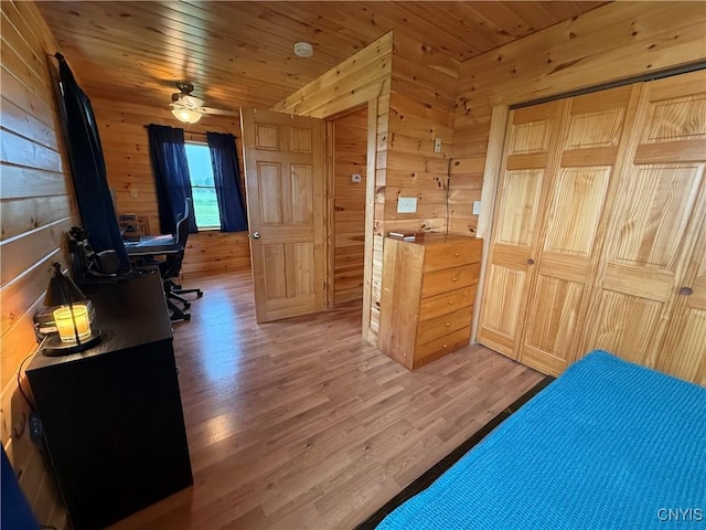 25003 State Route 37, Pamelia, NY 13601 - bedroom featuring wood walls, light wood-type flooring, wood ceiling, and a desk