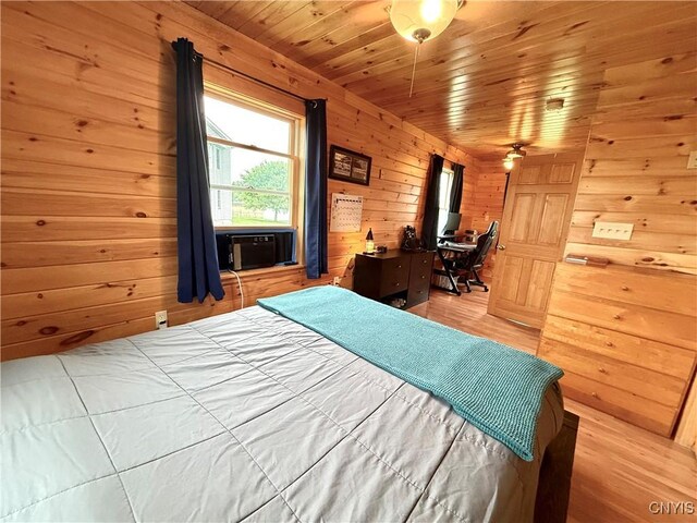 25003 State Route 37, Pamelia, NY 13601 - bedroom featuring wood walls, light wood-style flooring, wooden ceiling, and an office area