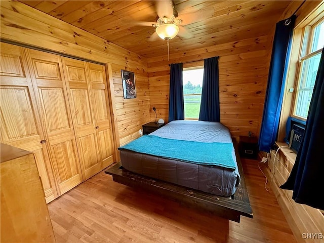 25003 State Route 37, Pamelia, NY 13601 - bedroom with light wood finished floors, wooden ceiling, wooden walls, ceiling fan, and cooling unit