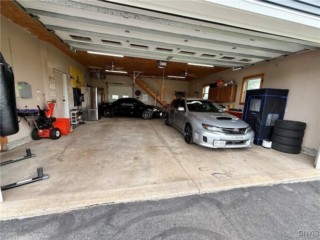 25003 State Route 37, Pamelia, NY 13601 - garage featuring a garage door opener and stainless steel fridge with ice dispenser