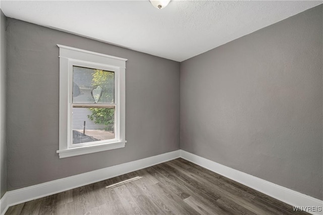 614 20th St, Niagara Falls, NY 14301 - spare room featuring dark wood finished floors and baseboards