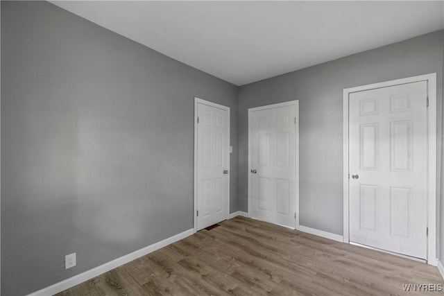 610 20th St, Niagara Falls, NY 14301 - unfurnished bedroom with wood finished floors and baseboards