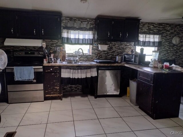 2771 Center Rd, Freetown, NY 13045 - kitchen featuring stainless steel appliances, ventilation hood, dark cabinetry, and healthy amount of natural light