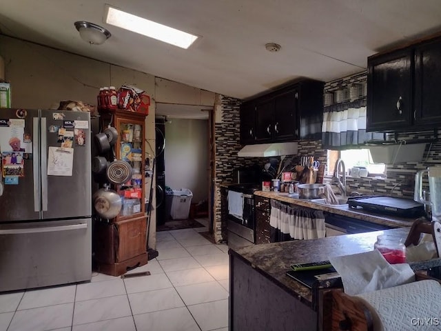 2771 Center Rd, Freetown, NY 13045 - kitchen featuring freestanding refrigerator, dark cabinetry, decorative backsplash, light tile patterned floors, and under cabinet range hood