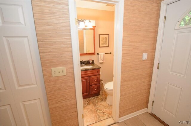 1215-29 James St, Syracuse, NY 13203 - half bath with vanity, toilet, and baseboards