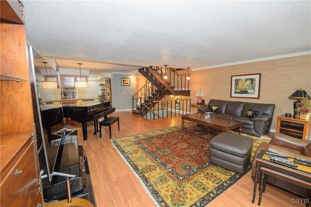 1215-29 James St, Syracuse, NY 13203 - living area with stairs, a textured ceiling, wood finished floors, and crown molding