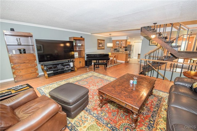 1215-29 James St, Syracuse, NY 13203 - living area with stairway, wood finished floors, ornamental molding, a textured ceiling, and baseboards