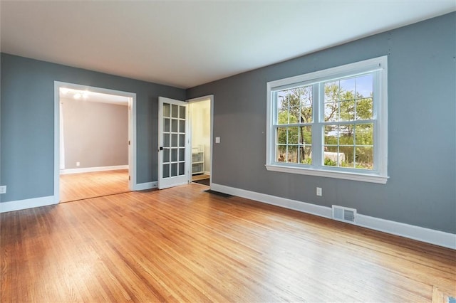 3215 E River Rd, Henrietta, NY 14623 - spare room with baseboards and light wood-type flooring
