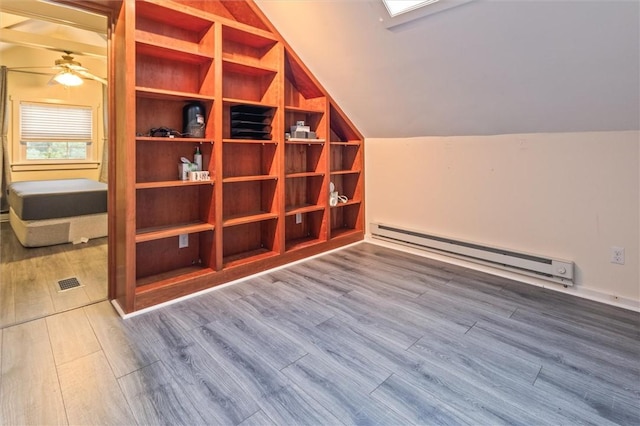 3215 E River Rd, Henrietta, NY 14623 - bonus room featuring a baseboard heating unit, wood finished floors, lofted ceiling, and a ceiling fan