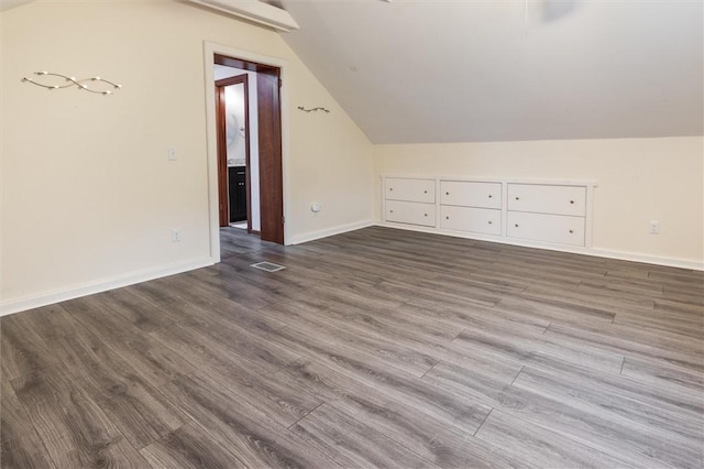 3215 E River Rd, Henrietta, NY 14623 - additional living space featuring lofted ceiling, dark wood-style flooring, and baseboards