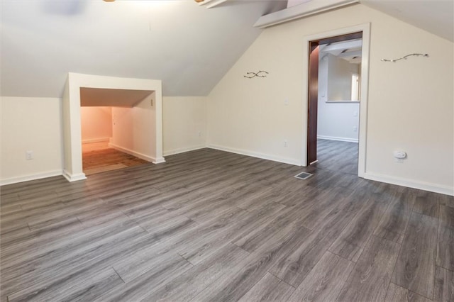3215 E River Rd, Henrietta, NY 14623 - bonus room featuring vaulted ceiling, wood finished floors, and baseboards
