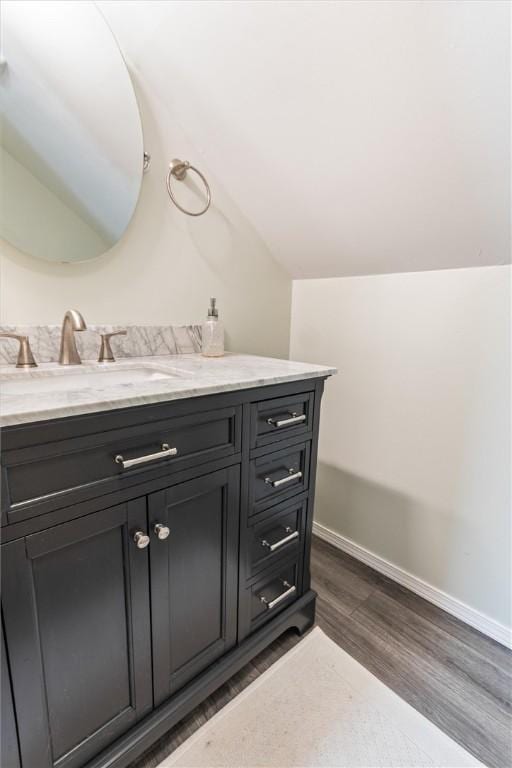 3215 E River Rd, Henrietta, NY 14623 - bathroom with wood finished floors, vanity, and baseboards