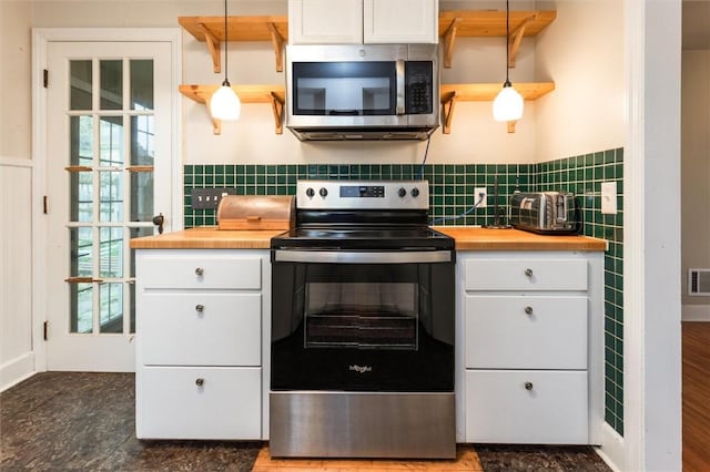 3215 E River Rd, Henrietta, NY 14623 - kitchen featuring appliances with stainless steel finishes, butcher block counters, white cabinets, and a wainscoted wall