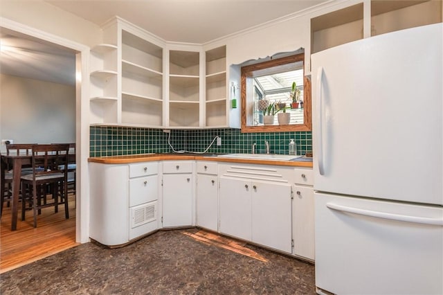 3215 E River Rd, Henrietta, NY 14623 - kitchen with freestanding refrigerator, open shelves, a sink, backsplash, and white cabinets