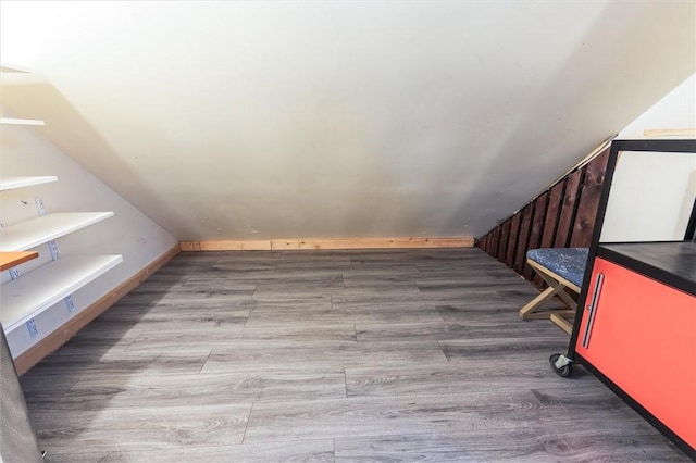 3215 E River Rd, Henrietta, NY 14623 - additional living space with wood finished floors and lofted ceiling