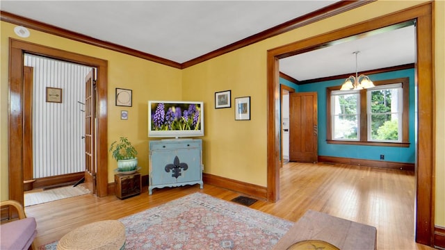 17 Varden St, Rochester, NY 14609 - foyer entrance with a chandelier, wood finished floors, baseboards, and crown molding