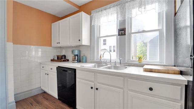 17 Varden St, Rochester, NY 14609 - kitchen with black dishwasher, a sink, light countertops, white cabinetry, and wood finished floors