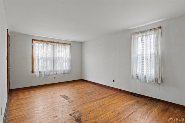 99 Kamper Ave, Buffalo, NY 14210 - spare room featuring healthy amount of natural light, wood finished floors, and baseboards