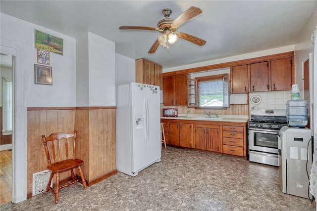135 Cameron St, Rochester, NY 14606 - kitchen with white fridge with ice dispenser, gas range, a sink, light countertops, and ceiling fan