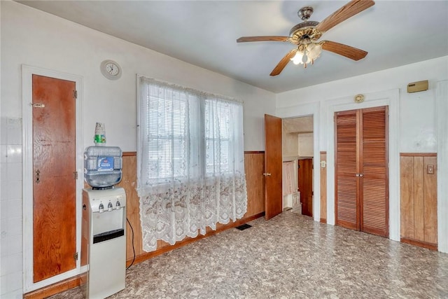 135 Cameron St, Rochester, NY 14606 - spare room with a wainscoted wall and ceiling fan