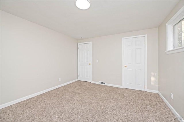 124 Aurora St, Rochester, NY 14621 - unfurnished bedroom with carpet and baseboards